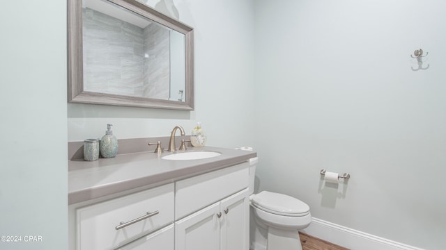 bathroom with hardwood / wood-style floors, vanity, and toilet