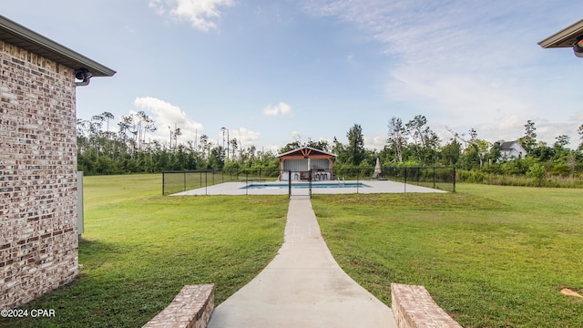 view of home's community featuring a pool and a lawn