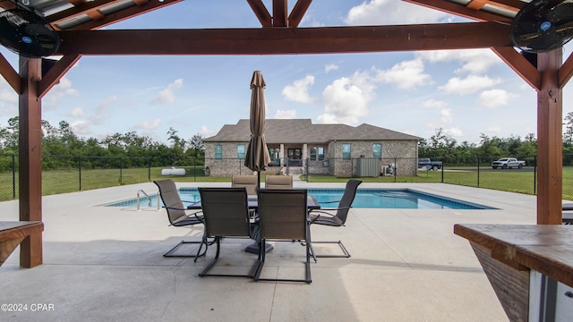 view of pool featuring a patio and a yard