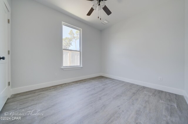 spare room with light hardwood / wood-style floors and ceiling fan