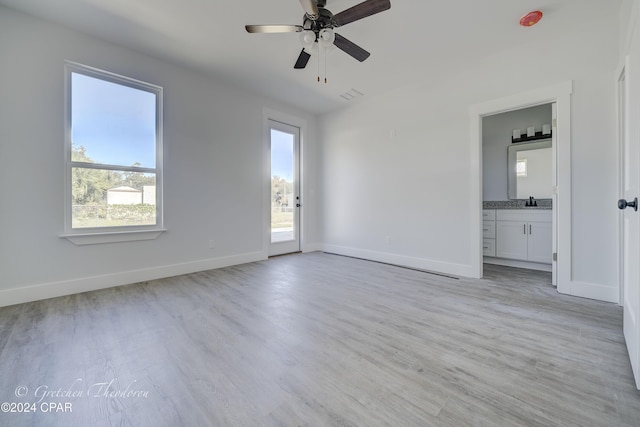 unfurnished room featuring ceiling fan, plenty of natural light, sink, and light hardwood / wood-style floors