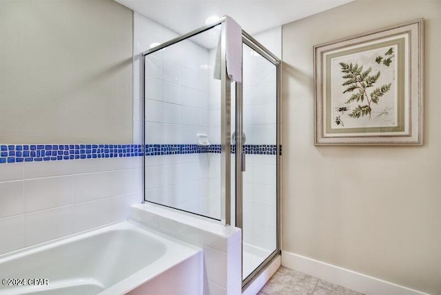 bathroom with tile patterned flooring and separate shower and tub