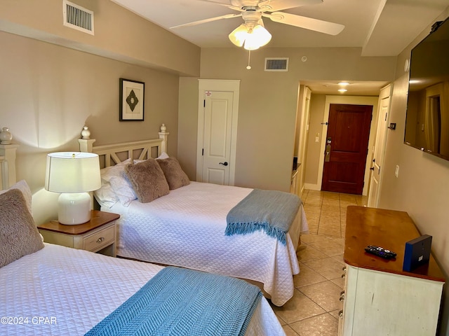 tiled bedroom featuring ceiling fan