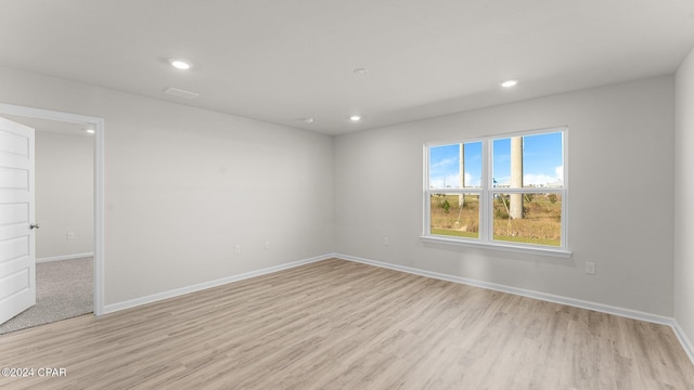 unfurnished room with light wood-type flooring