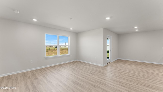 spare room featuring light wood-type flooring