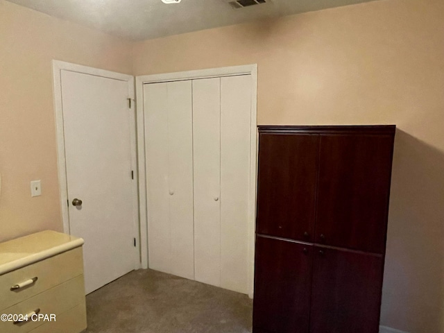 unfurnished bedroom featuring carpet flooring and a closet