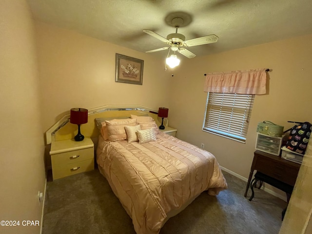 carpeted bedroom featuring ceiling fan and a textured ceiling