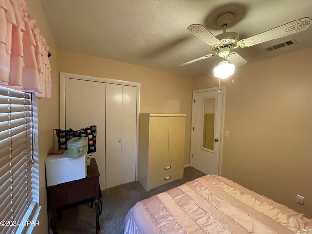 bedroom with a closet, ceiling fan, and dark colored carpet