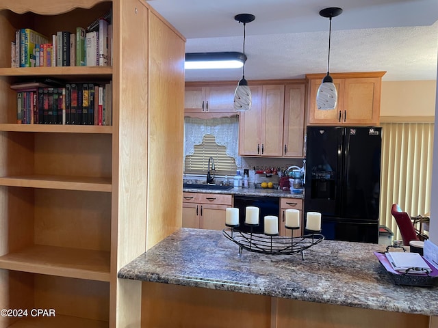 kitchen featuring dark stone counters, a textured ceiling, decorative light fixtures, black appliances, and sink