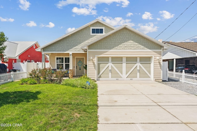 view of front of property featuring a garage and a front lawn