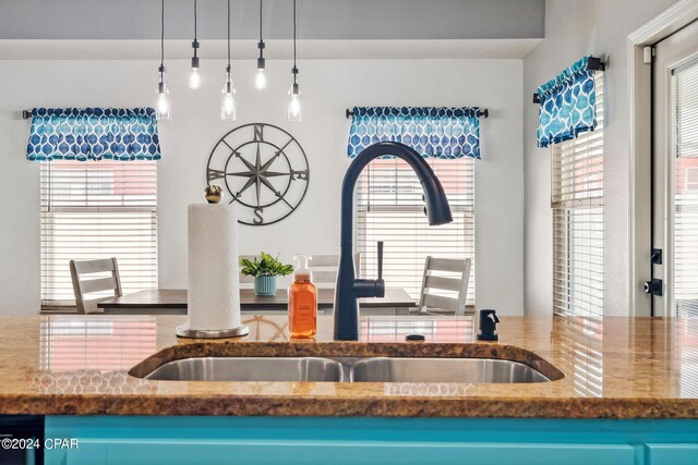 kitchen featuring dishwasher, hanging light fixtures, and sink