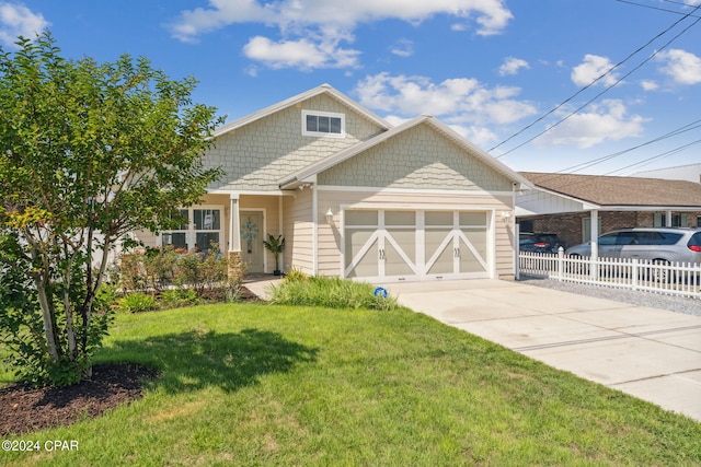 view of front of property with a garage and a front lawn