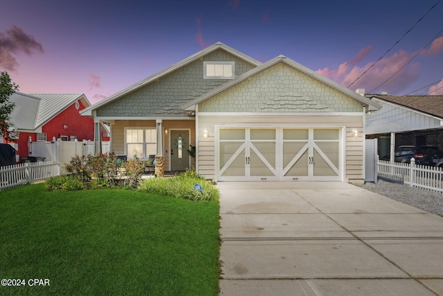 view of front of house featuring a yard and a garage