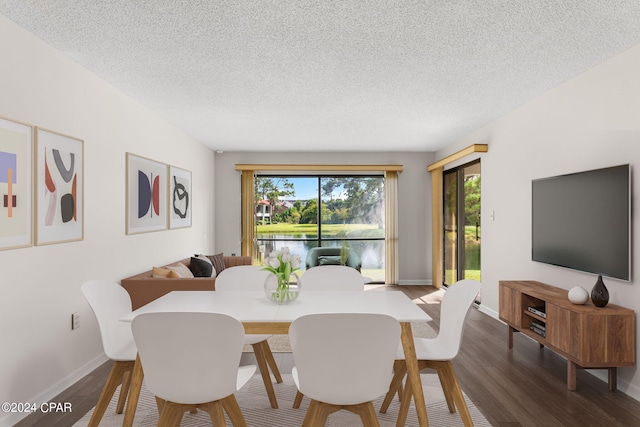 dining area featuring a textured ceiling and hardwood / wood-style flooring