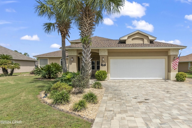 view of front of house featuring decorative driveway, an attached garage, a front lawn, and stucco siding