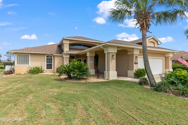 view of front of home featuring a garage and a front yard