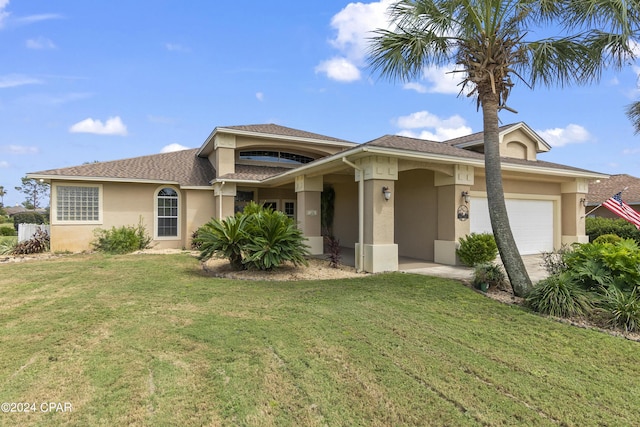 view of front of house with an attached garage, stucco siding, and a front yard