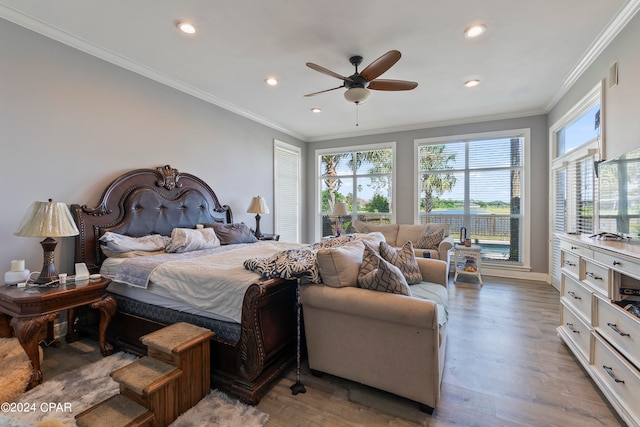 bedroom with crown molding, hardwood / wood-style flooring, and ceiling fan