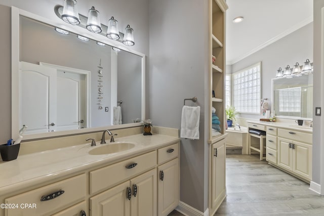 full bath featuring ornamental molding, vanity, and wood finished floors