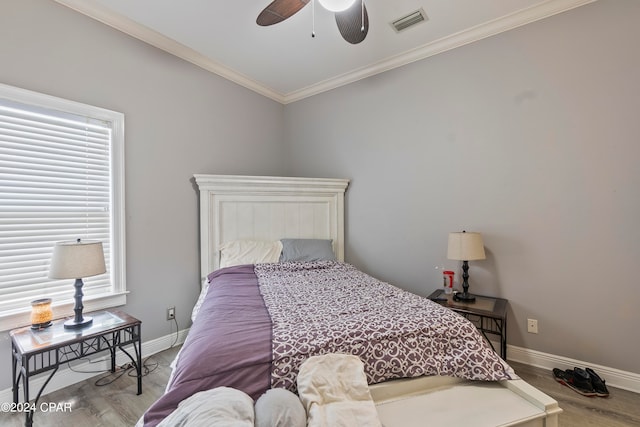 bedroom featuring crown molding, ceiling fan, and light hardwood / wood-style floors