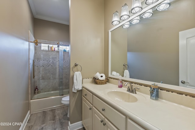 full bath featuring toilet, wood finished floors, bathtub / shower combination, crown molding, and vanity