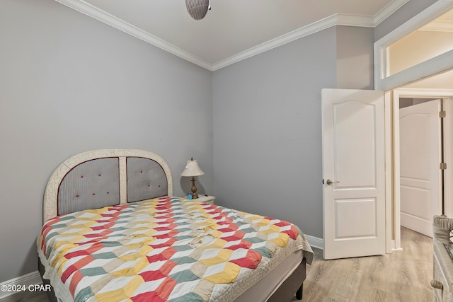 bedroom featuring crown molding and light hardwood / wood-style floors