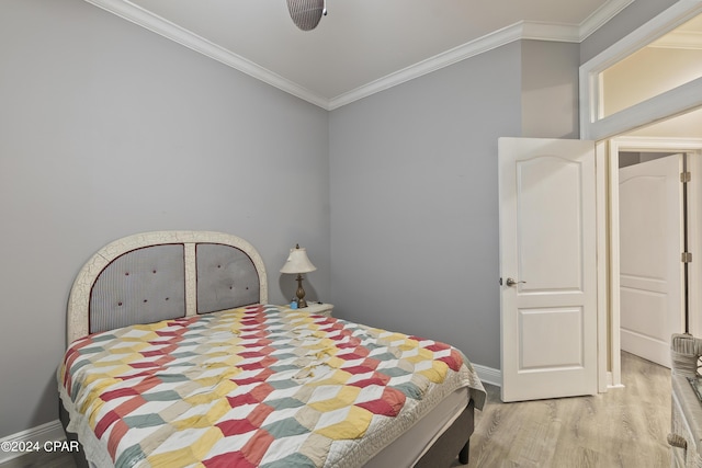 bedroom featuring light wood-style flooring, ornamental molding, and baseboards