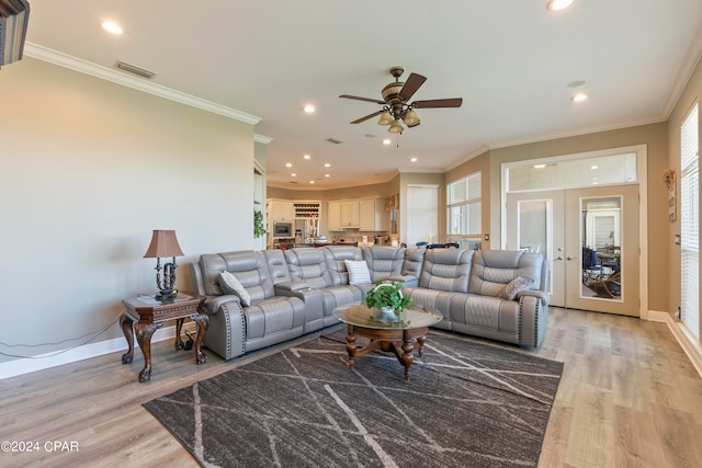 living room featuring french doors, ceiling fan, light hardwood / wood-style floors, and ornamental molding