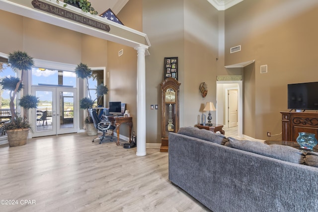 living room with french doors, light wood-type flooring, visible vents, and ornate columns