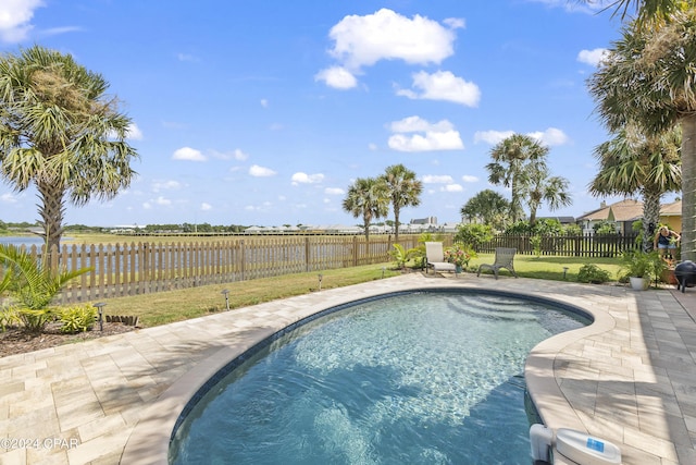 view of pool featuring a lawn, a patio area, a fenced backyard, and a fenced in pool