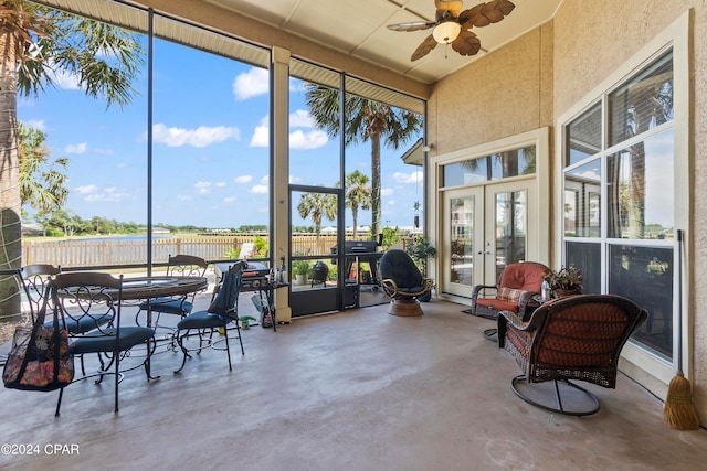 sunroom / solarium featuring ceiling fan and french doors