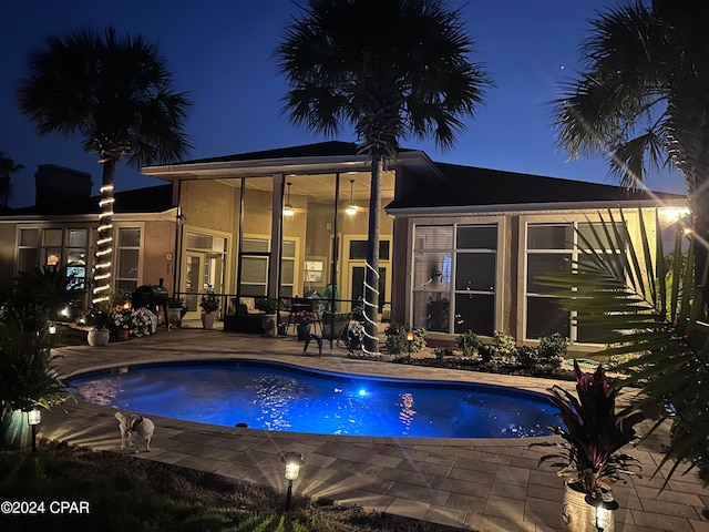 pool at twilight with a patio