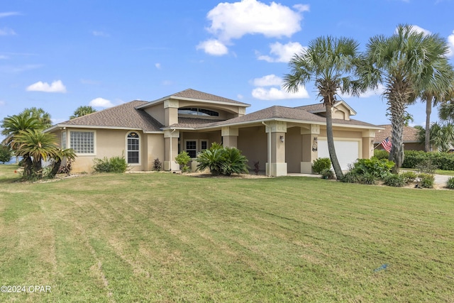 view of front of house with a garage, a front lawn, and stucco siding