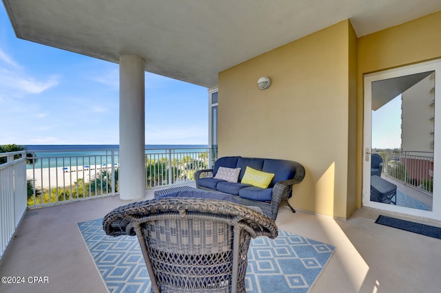 balcony featuring a view of the beach and a water view