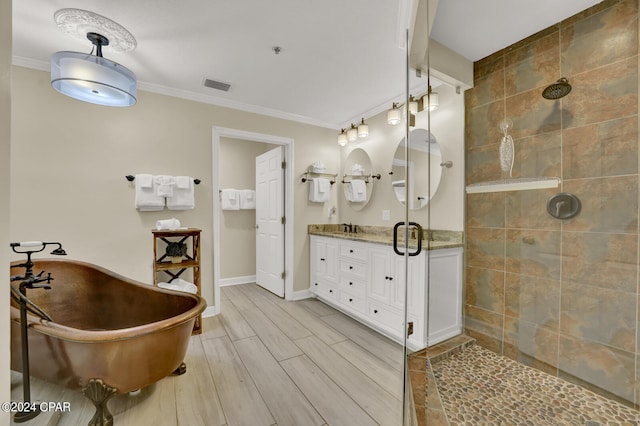 bathroom featuring ornamental molding, vanity, hardwood / wood-style floors, and shower with separate bathtub