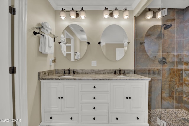 bathroom featuring a shower with shower door, crown molding, and vanity