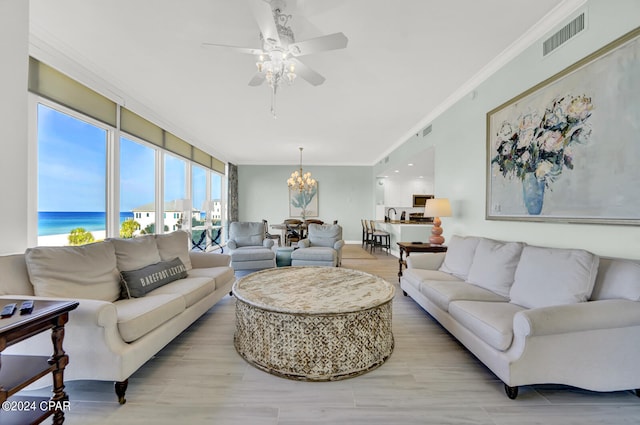 living room featuring a water view, ceiling fan with notable chandelier, light wood-type flooring, and ornamental molding