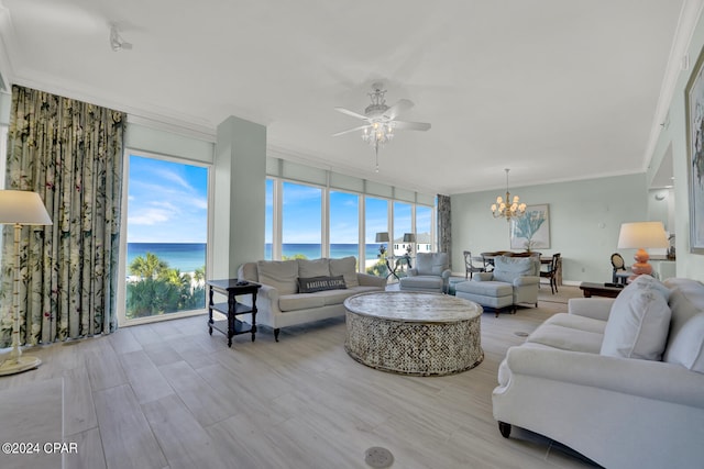 living room featuring light hardwood / wood-style flooring, ornamental molding, ceiling fan with notable chandelier, and a water view