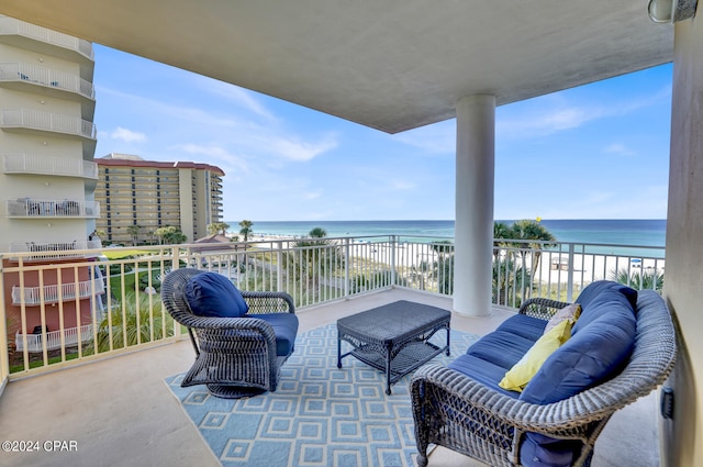 balcony featuring a view of the beach and a water view