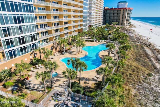 exterior space featuring a view of the beach, a water view, and a patio area