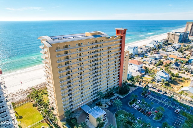 drone / aerial view featuring a beach view and a water view