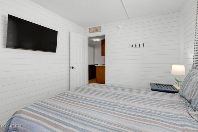 bedroom with wooden walls