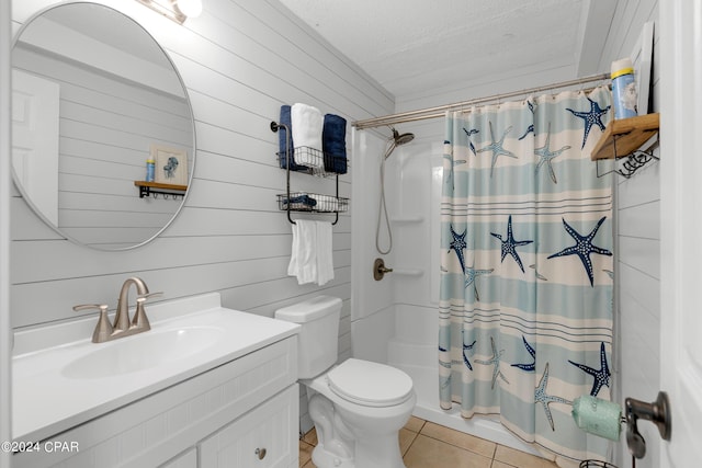 bathroom featuring a textured ceiling, tile patterned floors, vanity, toilet, and wooden walls