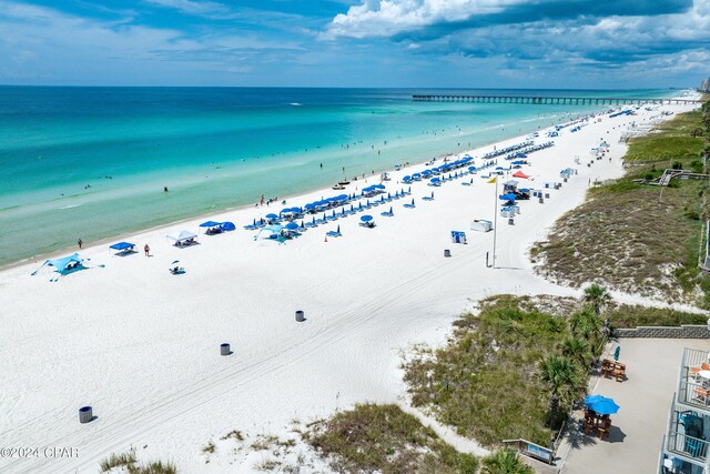 drone / aerial view with a beach view and a water view