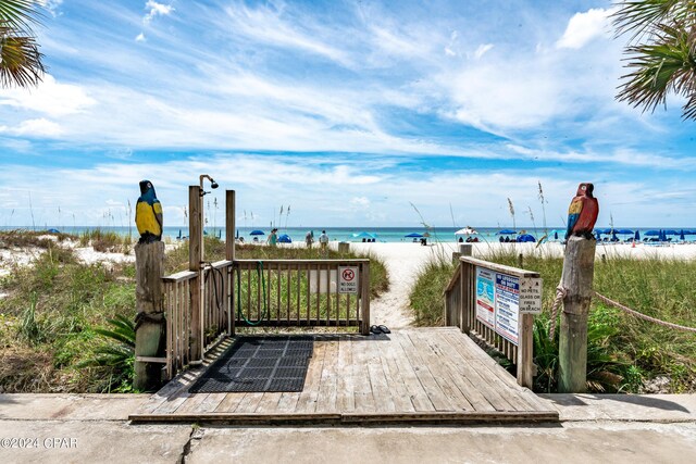 view of home's community featuring a water view and a beach view