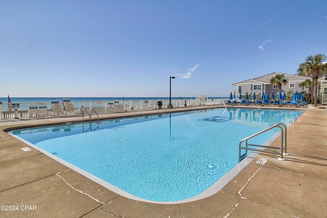 view of pool with a water view