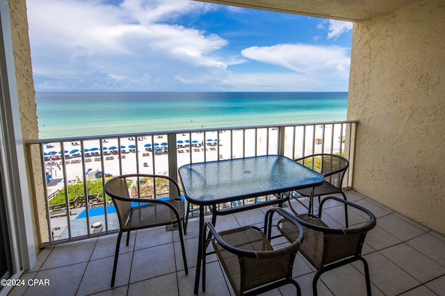 balcony featuring a water view and a view of the beach