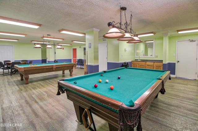 playroom featuring billiards, wood-type flooring, and a textured ceiling