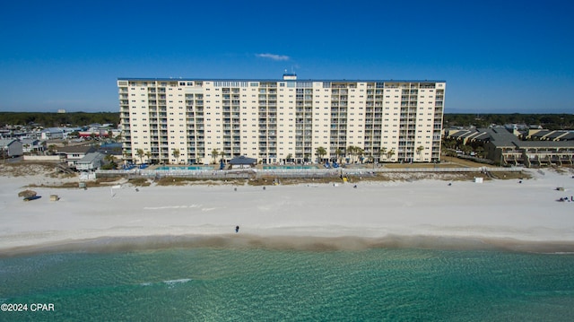 drone / aerial view featuring a water view and a view of the beach