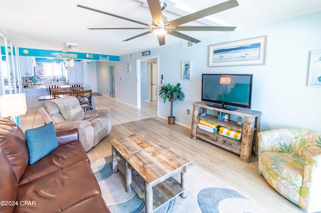 living room featuring light hardwood / wood-style flooring and ceiling fan